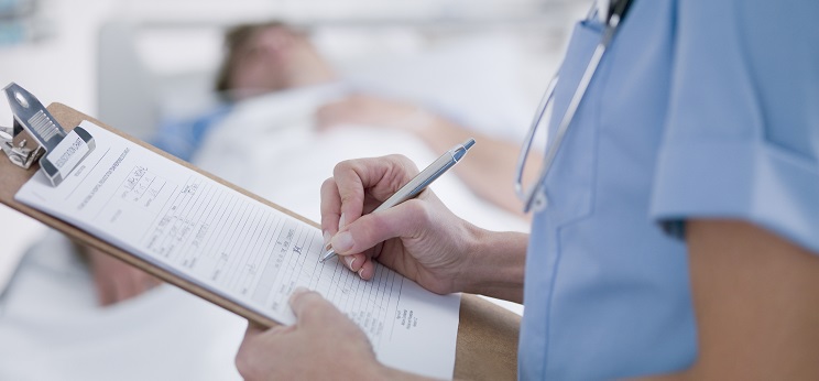 Nurse tending patient in intensive care